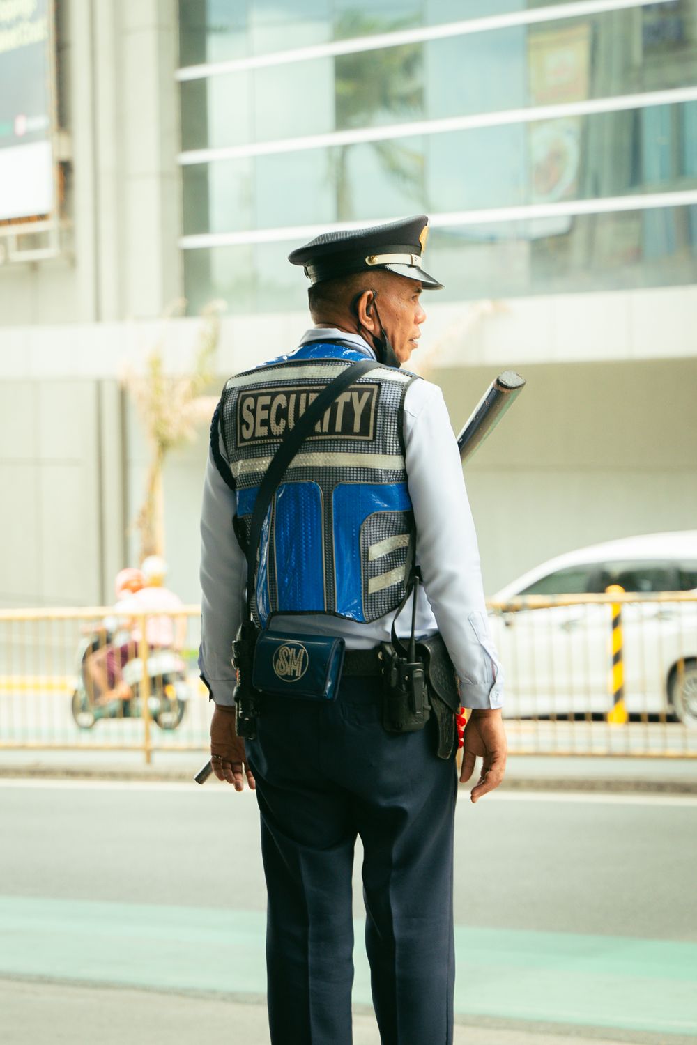 Security guard in uniform standing watch on a city street